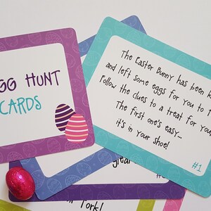 May include: Purple and blue Easter egg hunt clue cards with a colorful egg design. The first card reads "The Easter Bunny has been kind and left some eggs for you to find! Follow the clues to a treat for you, The first one's easy... it's in your shoe! #1"
