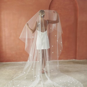Image of model wearing two-tier Cathedral length petal veil.