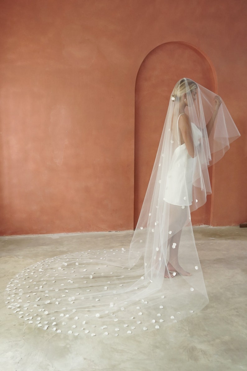 Model wearing petal wedding veil shown from her right side.