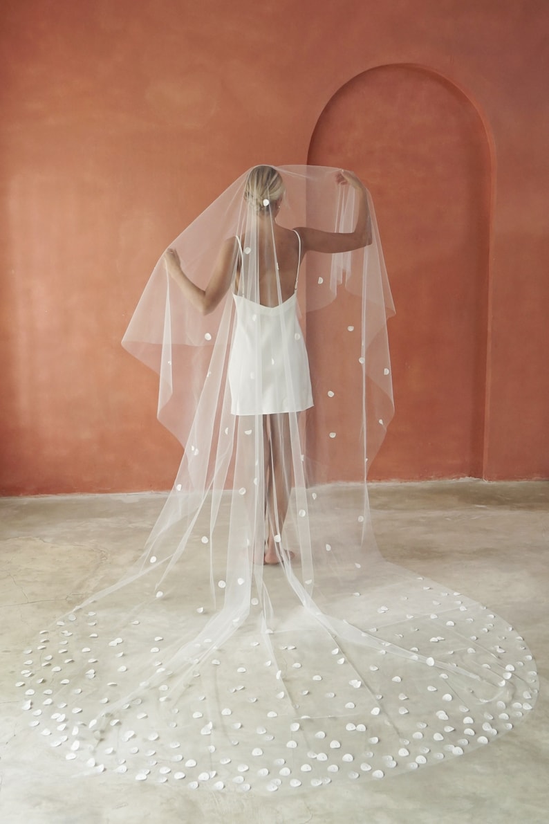 Image of model wearing two-tier Cathedral length petal veil.