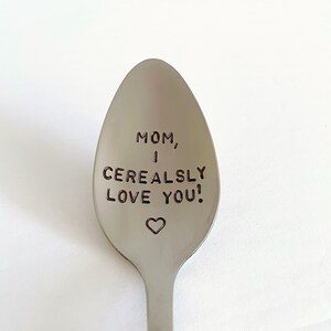 May include: A silver spoon with the words "MOM, I CEREALSLY LOVE YOU!" engraved on it. A small heart is engraved below the text.
