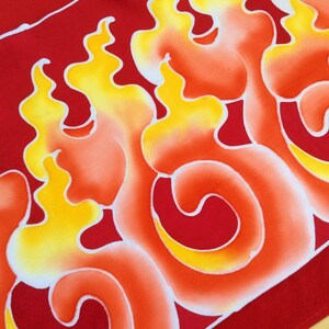 May include: Red fabric with a white and yellow flame design. The flames are stylized and have a gradient of orange, yellow, and white.
