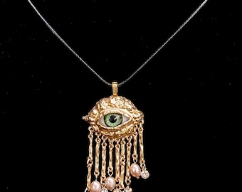 Onda ögat-hängsmycke: Blått öga, guldfärgad ram, pärlhängen