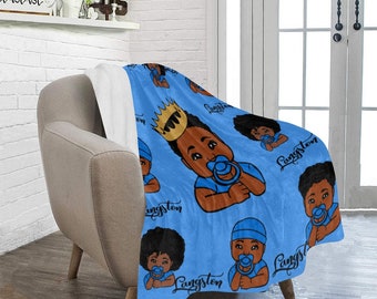 May include: Blue fleece blanket with a repeating pattern of a cartoon baby wearing a crown and a pacifier. The text "Gangster" is repeated on the blanket.