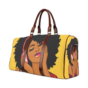May include: A yellow duffel bag featuring a graphic of a woman with closed eyes wearing pink headphones. The bag has brown leather handles and accents. The woman has dark skin, black hair, and pink lipstick.