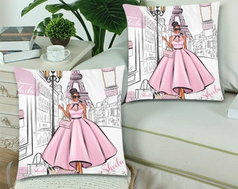 May include: Two white pillowcases with a black and white illustration of a woman in a pink dress walking in Paris. The Eiffel Tower is in the background. The pillowcases have the name "Sheila" printed on them.