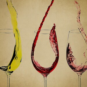 May include: Three wine glasses with red, white, and yellow wine pouring into them. The wine is splashing and creating a dynamic image.