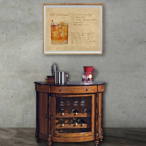 May include: A wooden bar cart with a glass door revealing a wine rack and glasses. The cart has a black marble top and a framed print of an Old Fashioned cocktail recipe.