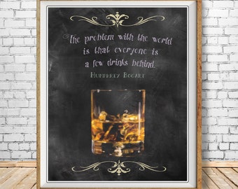 May include: A black chalkboard with a white quote by Humphrey Bogart that reads "The problem with the world is that everyone is a few drinks behind." A glass of whiskey with ice is pictured below the quote.