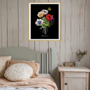 May include: A framed print of a botanical illustration of a bouquet of white, blue, and red anemones on a black background. The print is titled "Anemone".