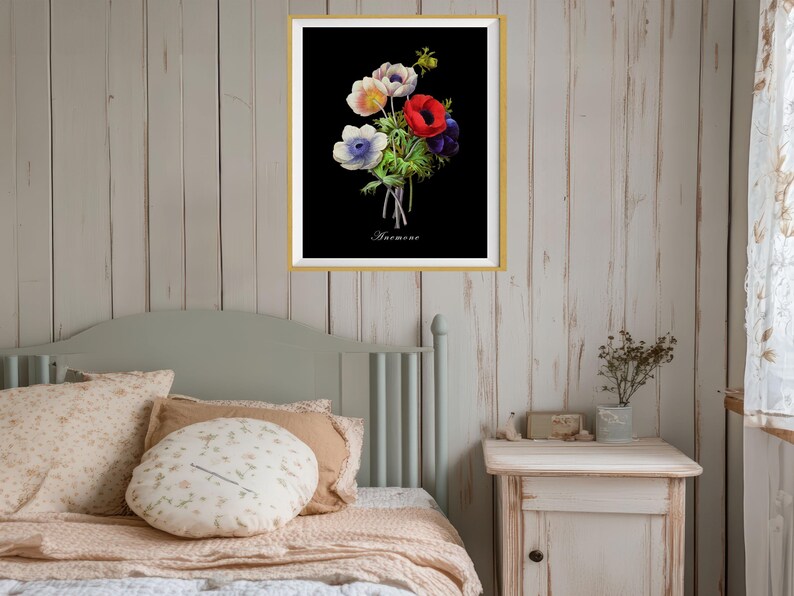 May include: A framed print of a botanical illustration of a bouquet of white, blue, and red anemones on a black background. The print is titled "Anemone".