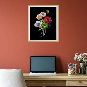 May include: A framed black and white botanical illustration of a bouquet of red, white, and blue anemones. The text "Anemone" is printed below the flowers.