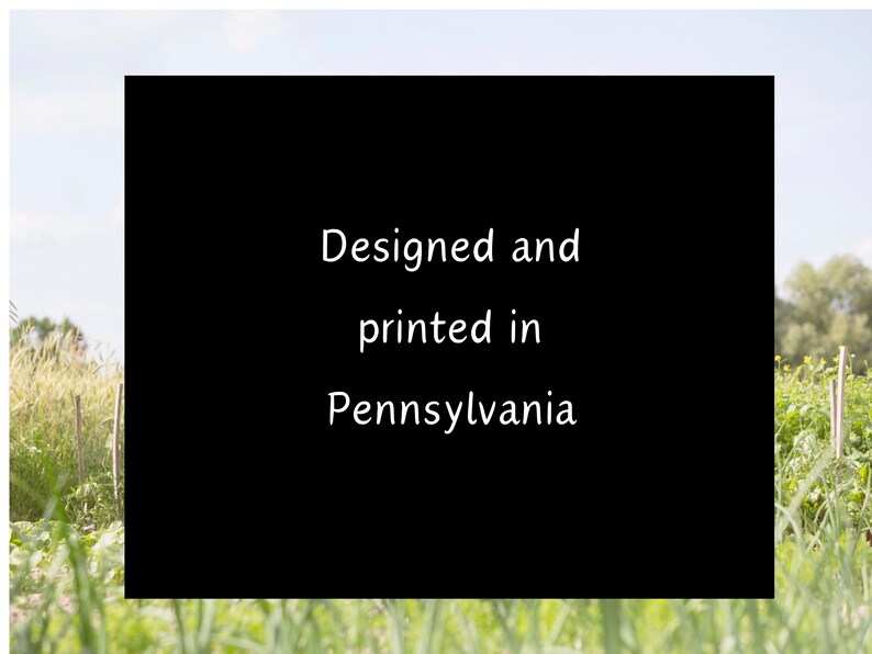 May include: Black and white text on a black background against a blurred background of green grass and a blue sky. The text reads "Designed and printed in Pennsylvania."
