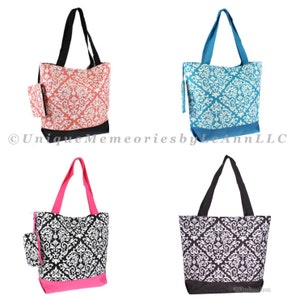 May include: Four tote bags with a damask pattern. The bags are in four different colors: coral, teal, black, and pink. Each bag has a small zippered pouch attached to the side.