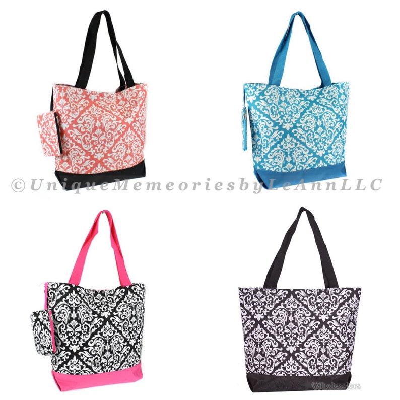 May include: Four tote bags with a damask pattern. The bags are in four different colors: coral, teal, black, and pink. Each bag has a small zippered pouch attached to the side.