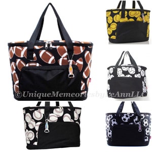 May include: Five different insulated lunch bags with various sports ball designs. The bags are black with a black zipper and a black pocket on the front. The bags have a black handle and a bottle opener attached to the zipper. The designs include footballs, baseballs, soccer balls, volleyballs, and softballs.