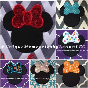 May include: A collage of nine different embroidery designs featuring a black silhouette of Mickey Mouse's head with various colored bows. The bows feature different patterns, including polka dots, paw prints, musical notes, and swirls.