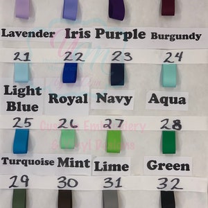 May include: A colour chart showing ribbon samples in various shades. The ribbons are labelled with colour names such as Lavender, Iris Purple, and Black. Each ribbon is numbered from 17 to 32.