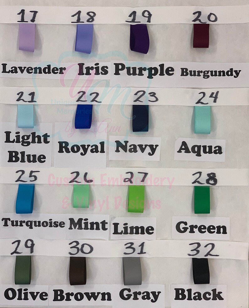 May include: A colour chart showing ribbon samples in various shades. The ribbons are labelled with colour names such as Lavender, Iris Purple, and Black. Each ribbon is numbered from 17 to 32.