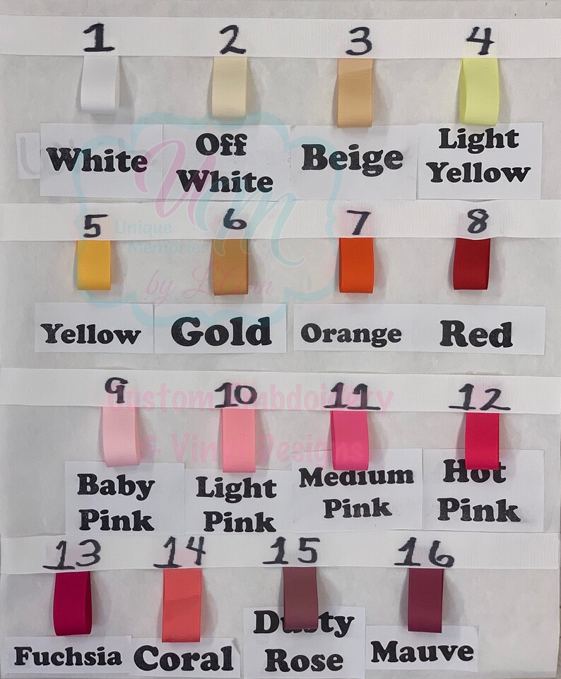 May include: A colour chart displaying sixteen ribbon swatches in diverse shades. Colours include white, off-white, beige, yellow, gold, orange, red, and various shades of pink and purple. Each swatch is labelled with its corresponding colour name.
