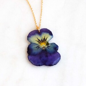 Pressed pansy flower pendant preserved in clear resin on gold chain