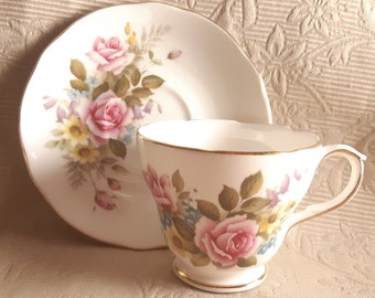 Duchess tea duo with floral on outside of cup and saucer, pink tea roses, forget me nots and meadow flowers on white tea cup and saucer