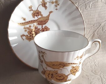 Royal Stafford chinoiserie style tea duo with gold pheasant and rust red outline on white fluted cup and saucer.