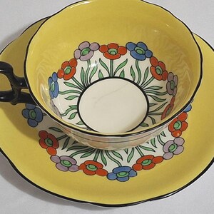 Discounted Aynsley Art Deco hand-painted floral teacup, bright yellow tea cup, flowers red blue,  black outlines, hand-painted, crack in cup
