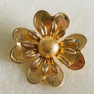 Vintage gold tone brooch of a four petal flower. Vintage costume jewelry, coat brooch, floral design