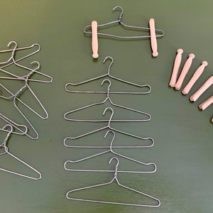 antique set of metal dolls clothes hangers and wood clothes pins