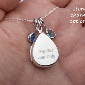 May include: Silver teardrop locket necklace with an inscription that reads "My One and Only". The locket has two small blue gemstone charms attached.