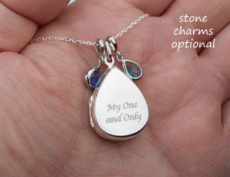 May include: Silver teardrop locket necklace with an inscription that reads "My One and Only". The locket has two small blue gemstone charms attached.