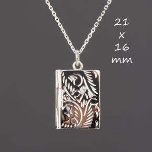May include: Silver locket necklace with a floral design. The locket is 21 x 16 mm.