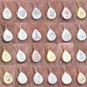 May include: A collection of 24 silver, gold, and rose gold teardrop-shaped lockets with various engraved designs. The lockets are on chains and feature designs such as trees, hearts, flowers, animals, and religious symbols.