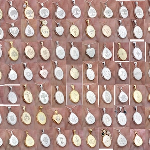 May include: A collection of oval and teardrop-shaped pendants on silver chains. The pendants feature various engraved designs, including trees, hearts, crosses, and other symbols. Some pendants are gold-toned, while others are silver-toned.