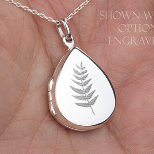 May include: Silver teardrop locket necklace with an engraved fern design. Shown with optional engraving.