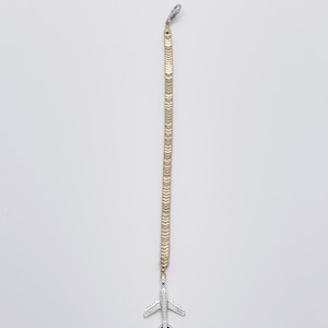 May include: A gold-toned chain with a repeating chevron pattern, featuring a silver-toned airplane charm attached at the bottom. The chain includes a small lobster claw clasp at the top, providing a secure attachment point for this jewelry accessory.