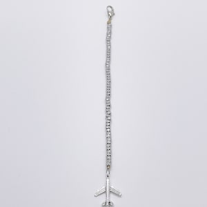 May include: A silver beaded bracelet with a silver airplane charm.