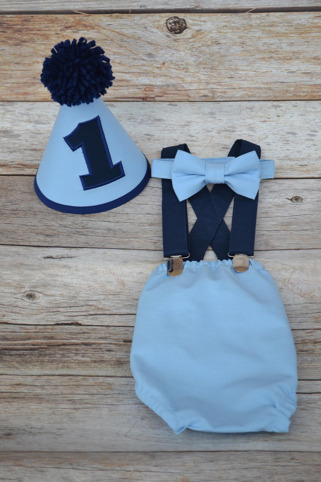 Light denim blue cake smash set for first birthday. Flat cap. Bow tie. Suspenders. Bloomer