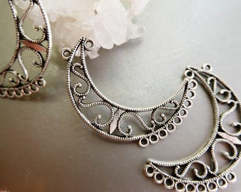 May include: Three silver-toned metal crescent moon charms featuring intricate filigree scrollwork patterns. Each piece has multiple small circular loops along the outer edge for attachment, showcasing a detailed openwork design with a metallic finish.