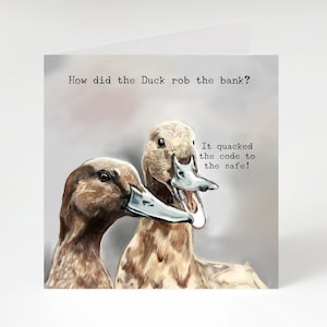 May include: A humorous greeting card featuring a cartoon illustration of two ducks. The text on the card reads: "How did the Duck rob the bank? It quacked the code to the safe!"