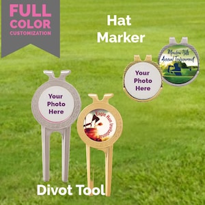 May include: A gold and silver golf hat marker with a divot tool. The marker has a round, white surface with the text "Your Photo Here". The divot tool has a gold surface with a picture of a golf scene and the text "Eagle Run Invitational".