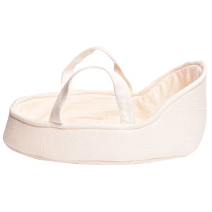 May include: A cream-colored doll bassinet with a striped lining and two fabric handles.