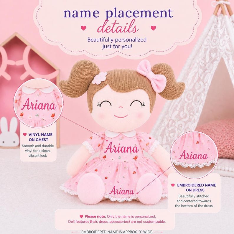 May include: A plush doll with brown hair in pigtails, a pink bow, and a pink floral dress. The text 'Ariana' is displayed on the chest and the bottom of the dress. The image includes text detailing name placement options and a 3-inch wide embroidery note.