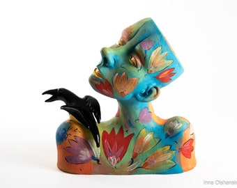 ceramic bust man looking up with black bird colorful sculpture by Inna Olshansky