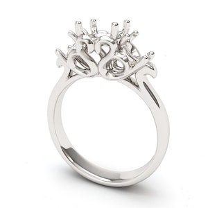 May include: A silver ring setting with a three-prong design. The setting is designed to hold three stones.