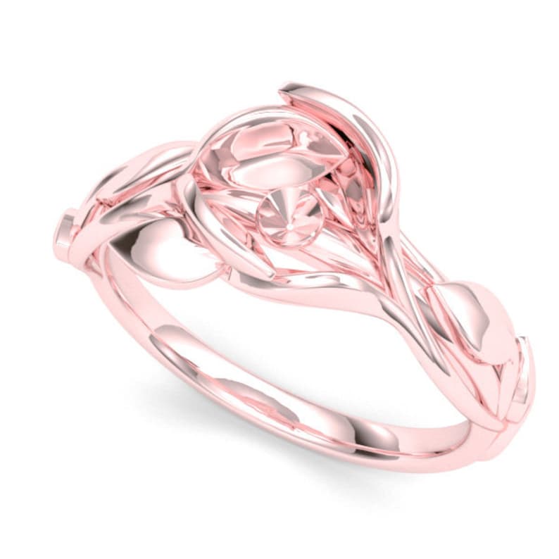 May include: A rose gold ring with a delicate floral design. The ring features a central stone and intricate details that resemble leaves and petals.