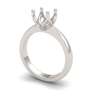 May include: A silver ring setting with a prong setting for a center stone.