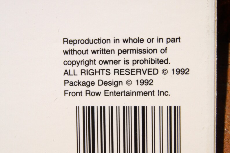 May include: A white label with black text that reads "Reproduction in whole or in part without written permission of copyright owner is prohibited. ALL RIGHTS RESERVED &copy; 1992 Package Design &copy; 1992 Front Row Entertainment Inc."
