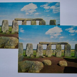 May include: A postcard featuring a photograph of Stonehenge, a prehistoric monument in Wiltshire, England. The image shows the iconic stone circle with a blue sky and white clouds in the background.
